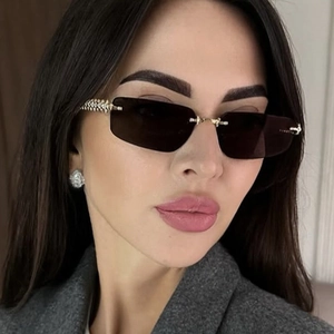 Detail view of rimless rectangle sunglasses with textured golden metal temples on model