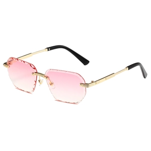 Polygon rimless sunglasses with pink gradient lenses and gold metal frame from 45-degree angle