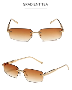 Detail of rimless square sunglasses featuring gradient tea lenses and gold textured arms