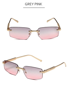 Detail of grey pink rimless sunglasses with gold metal temples and textured rivets