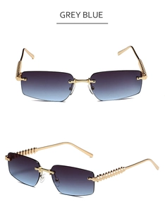 Detail of rimless grey blue gradient sunglasses with gold metal studs and textured temple