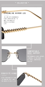 Detail of gold metal rimless sunglasses showing gray lenses and textured temple hinges