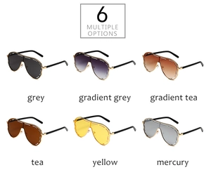 Flat lay of oversized one-piece sunglasses in six assorted colors and metallic temples