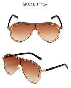 Detail view of large frame oversized sunglasses with gradient tea lenses and gold metal frame