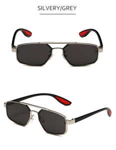 Détail de lunettes de soleil géométriques en métal avec double pont et embouts rouges