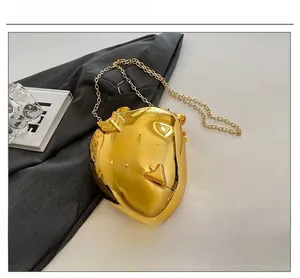 Chic heart-shaped gold metallic evening bag with sleek chain strap and mirror finish