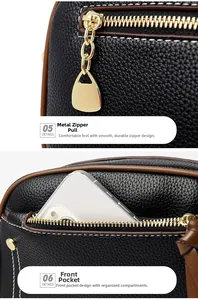 Detailed view of black litchi grain leather shell bag with golden zipper and front pocket