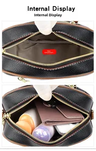 Internal display of black lychee leather handbag showing main pocket and interior capacity