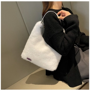 Detail of white plush tote bag with purple Fashion Girl label and slim shoulder strap