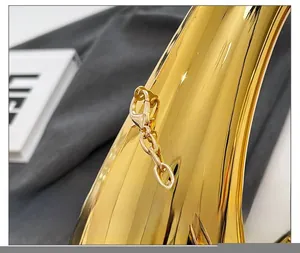 Detailed close-up of premium polished gold lobster clasp and chain on acrylic evening bag
