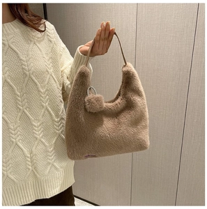 Detail of khaki plush hobo bag with furry texture and metal ring buckle detail