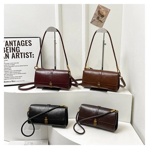Group view of four leather handbags in burgundy, tan, black, and brown with gold buckles