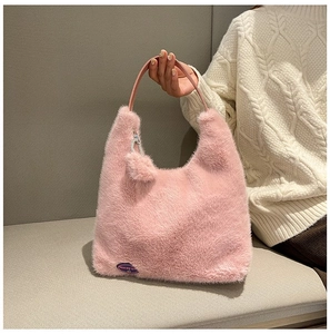 Detailed close-up of pink faux fur tote bag showing the soft texture and logo detail
