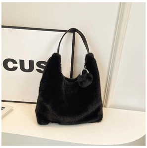 Detail of black faux fur hobo bag with leather handle and sparkling rhinestone charm
