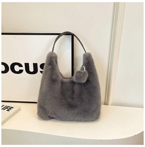Detailed close-up of soft grey faux fur texture on a crescent shoulder bag with strap