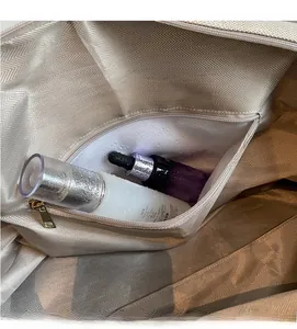 Detail view of the dry-wet separation waterproof zip pocket inside the golden travel bag
