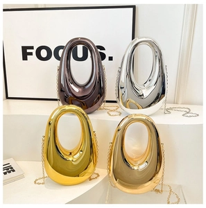 Macro detail of acrylic evening bags in liquid metal finishes with chain straps