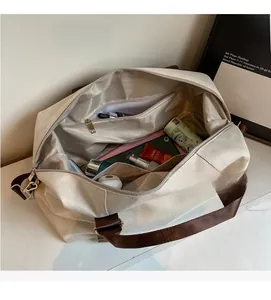 Interior detail of a canvas travel bag showing a zipper pocket and large storage capacity