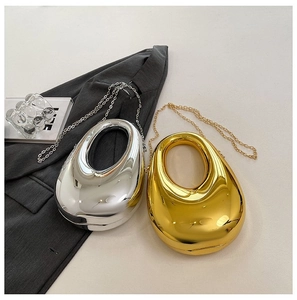 Top view of gold and silver egg-shaped acrylic clutch bags with metal mirror finish