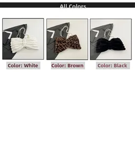 Three bow-shaped plush handbags in white, brown leopard and black with pearl handles