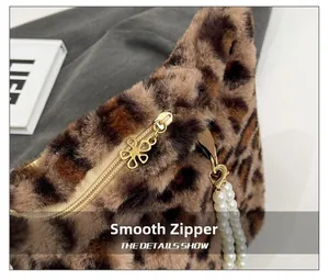 Detail of leopard print faux fur bag with golden flower zipper and pearl pendant decoration