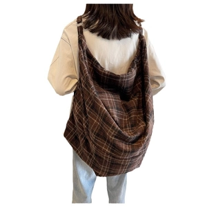 Large brown plaid canvas tote bag for women showing crossbody style on a model