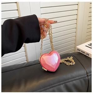 Pink heart-shaped evening bag with geometric facets and golden metal chain strap