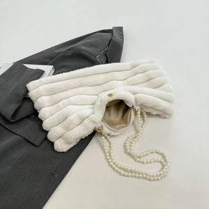 White faux fur handbag with pearl straps and striped texture on a grey blazer