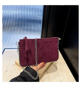 Burgundy suede chain bag with silver beaded edges and metallic shoulder strap detail