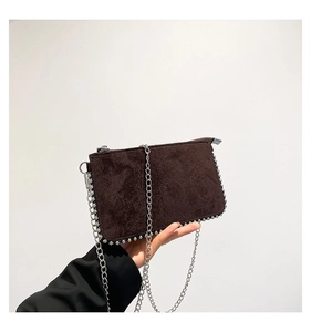 Detail view of coffee frosted leather shoulder bag with silver studs and chain strap