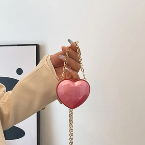 Detailed close-up of pink heart-shaped acrylic mini bag with faceted diamond texture