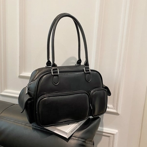 Detail of black faux leather Boston bag featuring multiple exterior zipper pockets and silver hardware