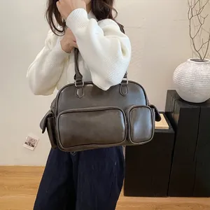 Detailed view of the dark brown retro leather shoulder bag with functional pockets