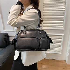 Detail showing a black multi-pocket crossbody bag with silver hardware and PU leather texture
