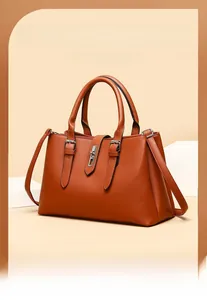 Detail of vintage brown lychee leather tote bag with silver metal twist lock and top handles