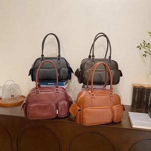 Detailed view of four vintage leather crossbody bags in black, coffee, burgundy and tan