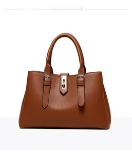 Close-up of brown PU leather tote bag featuring stitching details and silver metal twist lock