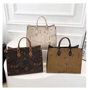 Three elegant tote bags in beige, dark coffee, and caramel colors on a white pedestal
