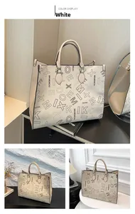 Detailed view of beige tote bag with letter print and sturdy top handles for women