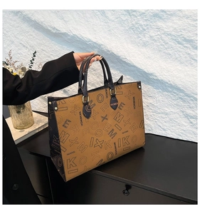 Detail of tan tote bag with contrast piping and luxury letter print for women