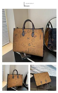 Detail of a brown tote bag featuring letter print patterns and dark contrast handles