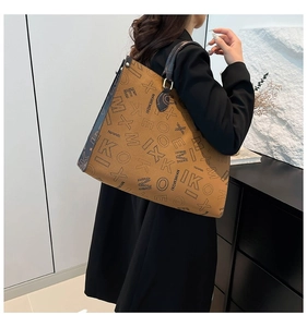 Detailed side view of a brown leather tote bag with blue trim worn by a model
