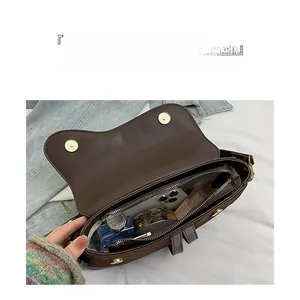Detailed interior of vintage saddle bag showing large capacity and zipper compartments