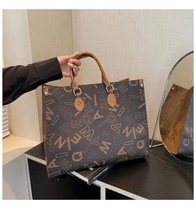 Detail of QIANWEI tote bag jacquard pattern with brown handle on storage cabinet