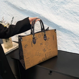 Brown tote bag with dark letter print and golden metal buckles on a minimalist background