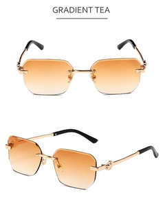 Detail of rimless hexagonal sunglasses featuring gradient tea lenses and gold metal frame