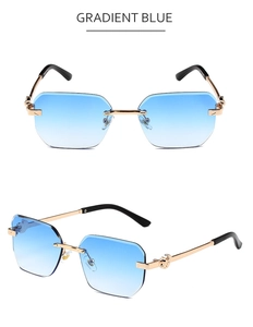 Detail view of rimless gradient blue sunglasses with gold metal temples and embossed patterns