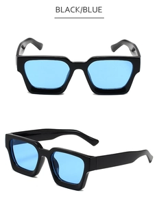 Détail de lunettes de soleil rectangulaires avec monture épaisse et verres bleus