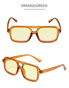 Detail of square pilot sunglasses with orange double bridge frame and green tinted lenses