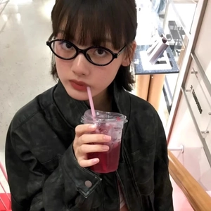 Asian model wearing retro black oval glasses frames with a vintage grey jacket